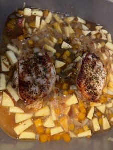 Pork Chops with butternut squash and apples in pan